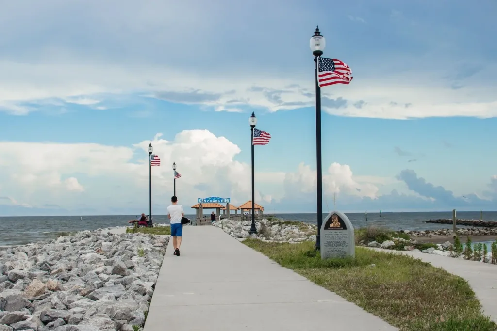 Man walking along Ken Combs Pier | Gulfport Mississippi Industrial Vacuums and Cleaning for Maritime and Refineries Industries